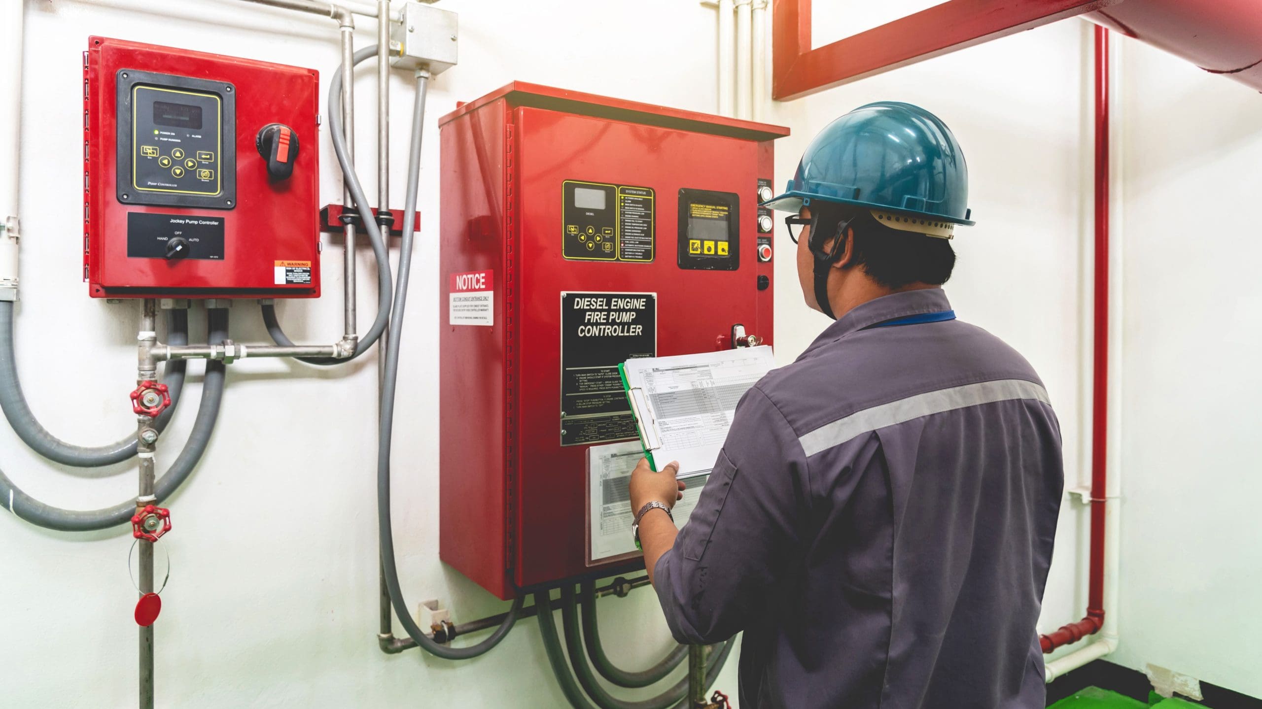 Engineer checking industrial generator fire control system, Diesel engine fire pump controller