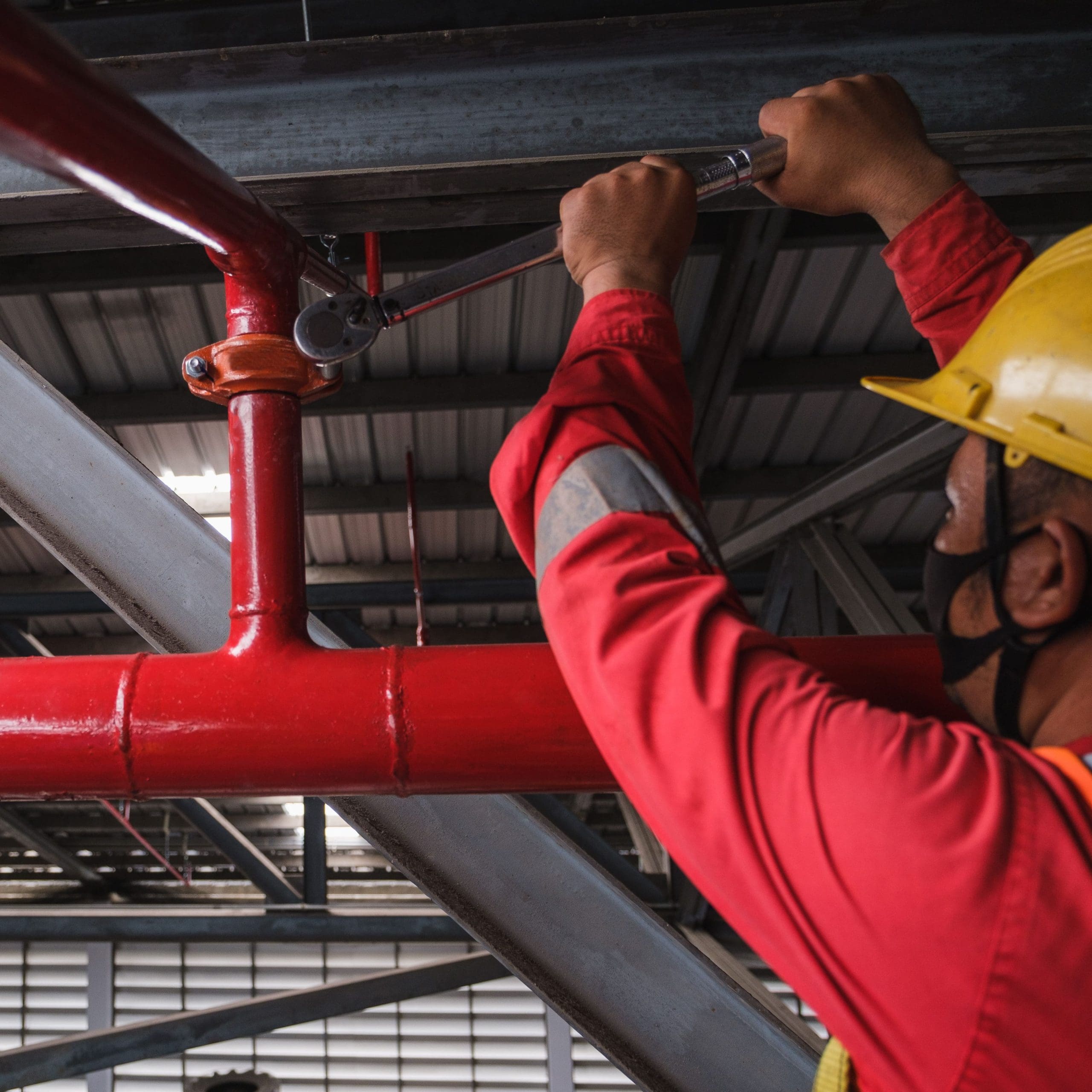 Install fire sprinkler system. In the industrial plant, pipe assembly, red fire pipe, fire protection contractors Using Scissor Lift High work